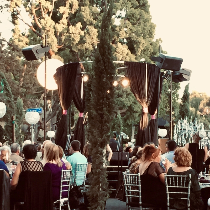 Outdoor stage with people dining